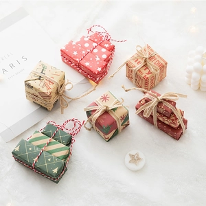 Mini Christmas gift box set with red and green patterns on white fluffy background