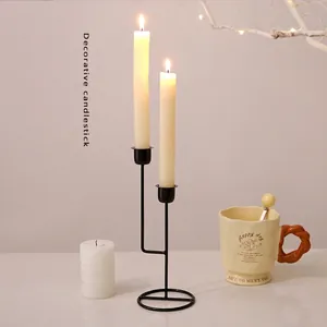 Modern black iron dual-head candle holder with minimalist round base for dining table decor