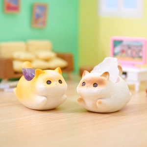 Cute resin cat figurines with purple and white crystal accents on wooden surface