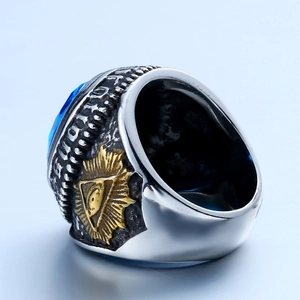 Macro detail of vintage Masonic ring with blue gemstone and gold All-Seeing Eye relief