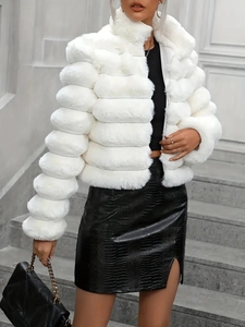 Detail of white faux fur jacket with horizontal stitching and black leather skirt