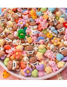 Macro view of assorted 3D cartoon resin charms including bears and flowers for DIY crafts