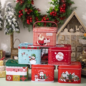 Stack of festive Christmas tin boxes with metal handles and Merry Christmas holiday designs