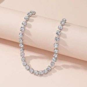 Detailed view of silver choker necklace with shimmering diamonds on a pink pedestal