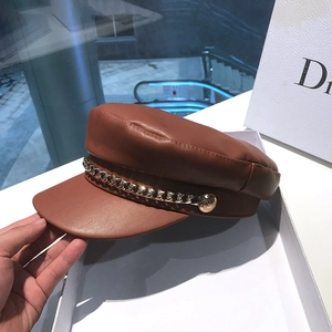 Detailed close-up of brown PU leather newsboy hat featuring decorative gold chain and buttons