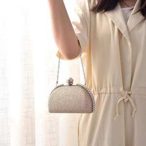 Elegant gold glitter evening clutch bag with pearl trim and delicate chain strap