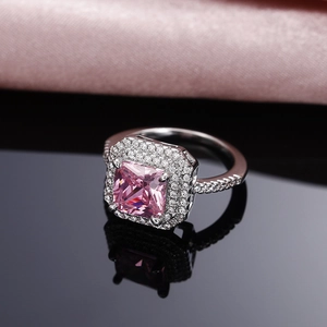 Macro view of luxurious pink square zircon ring with double halo pavé diamond setting
