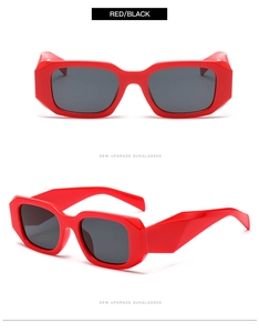 Detail view of red chunky geometric frame sunglasses with dark gray lenses
