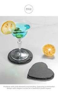 Macro detail of dark grey heart and round slate coasters with natural split edges