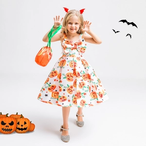 Detail of girls' Halloween pumpkin dress with white base and star patterns