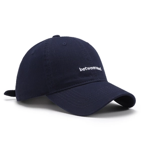 Dark blue washed cotton baseball cap with white letter embroidery in a side profile view