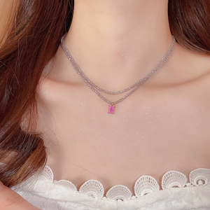 Macro shot of double-layered beaded necklace with a pink rectangular zircon pendant