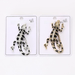 Detail of enamel lizard brooches with rhinestones in gold and silver finish settings
