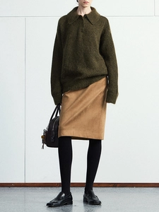 Detail shot of camel suede straight skirt with a sophisticated side slit and soft texture