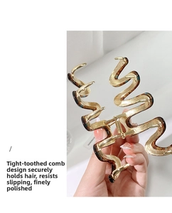 Detail of handmade wavy S-shaped metal hair claw clip with brown tortoiseshell resin