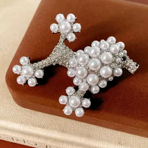 Vintage Poodle Pearl Brooch with rhinestones on a brown velvet jewelry gift box