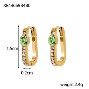 Detail view of U-shaped gold earrings with green stones and clear size dimensions