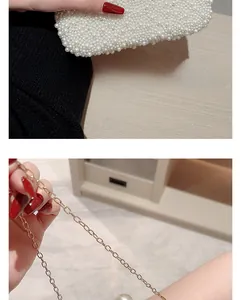 Close-up of elegant pearl beaded evening clutch with gold chain strap detail