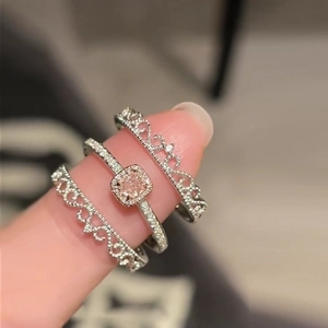 Three-piece ring set with silver crown design and a central pink square zircon stone