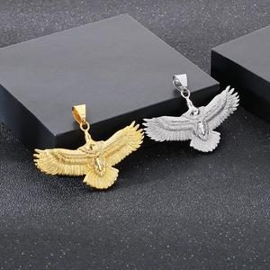 Detailed view of 18k gold and silver eagle pendants with intricate feather textures