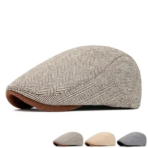 Men's British style newsboy cap in grey herringbone tweed with adjustable strap