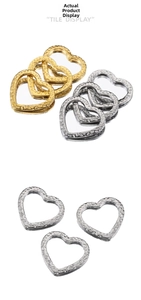 Close-up of heart-shaped stainless steel pendants with hammered metal texture in gold and silver