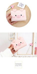 Detailed view of pink cartoon pig wallet with 3D heart ears and soft PU leather texture