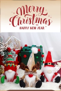 Close-up of three festive Christmas gnomes with knit hats on white faux fur surface
