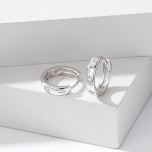 Detailed close-up of S925 sterling silver star hoop earrings with micro-set zircon