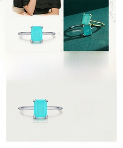 Detailed view of 925 sterling silver ring with 6x8mm emerald cut cyan gemstone