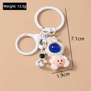 Detailed view of white PVC space rabbit keychain with astronaut pendant and dimensions