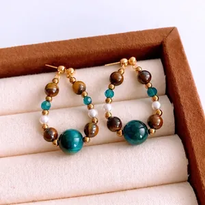 Bohemian tiger eye bead drop earrings with blue accents and pearls in a vintage jewelry box