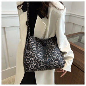 Detail of soft leopard print tote bag with wide shoulder strap and decorative knot detail