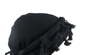 Close-up detail of black men's headwrap with satin lining and decorative fringe tassels