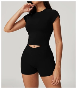Close-up of black quick-dry yoga set featuring V-waist shorts and a crop top