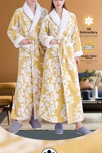 Detail of warm yellow fleece bathrobe with white 3D floral pattern and cozy textures