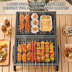 Portable double-layer charcoal BBQ grill with chicken wings and skewers on a wooden table