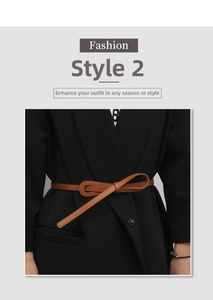 Brown slim leather belt tied in a bow over a black blazer for a stylish waist accent