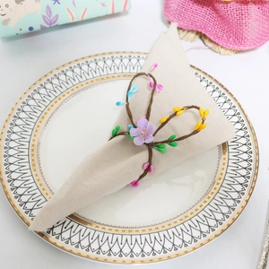 Detailed shot of lavender floral napkin ring with colorful berries on a decorative plate