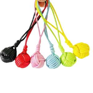 Handwoven monkey fist knot keychains in six vibrant colors displayed on a white background
