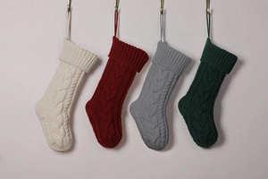 Detailed knit Christmas stockings in cream, red, grey and green with cable textures