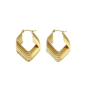 Close-up of geometric layered gold earrings with a modern hollow diamond-shaped design
