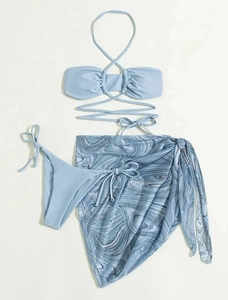 Three-piece light blue bikini set featuring marble print sarong and crisscross straps