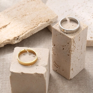 Minimalist adjustable stainless steel rings in gold and silver finish on stone props