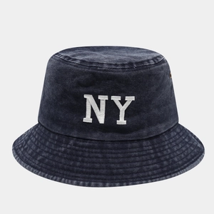 Detail of NY logo embroidery and premium stitching on navy blue bucket hat