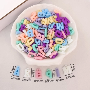 Macro shot of colorful acrylic alphabet beads in a shell bowl with size dimensions