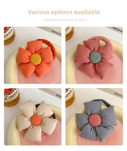 Detail of colorful fabric flower hair ties with plush petals in four different colors