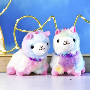 Detail shot of two cute rainbow plush alpaca keychains with colorful bead necklaces