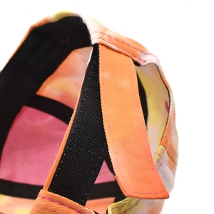 Detail of colorful tie-dye baseball cap featuring adjustable black Velcro strap and stitching