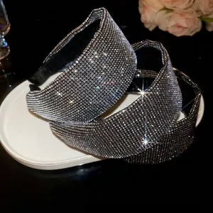 Luxury wide rhinestone headbands for women featuring glittering silver crystals on black base